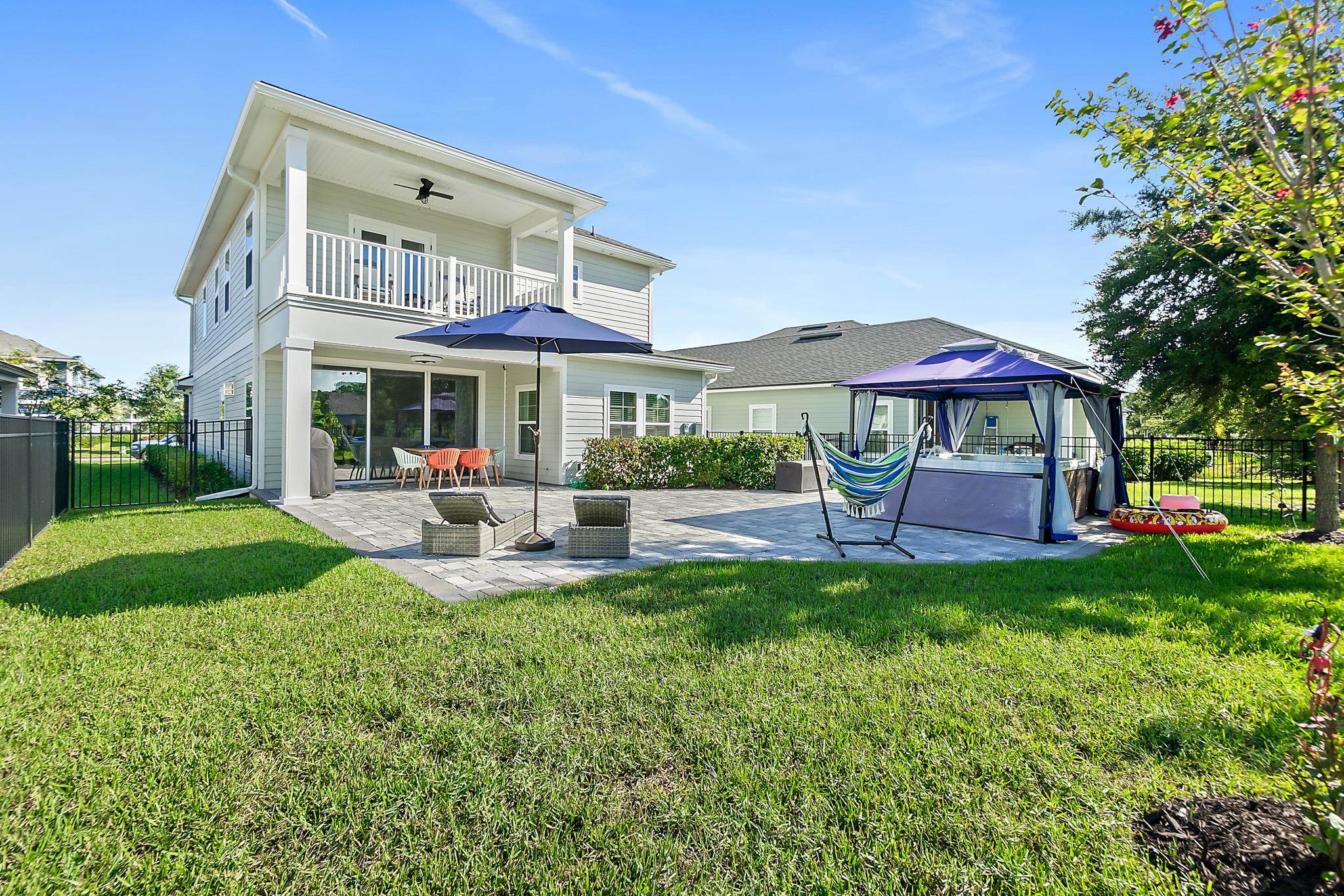 157 Ferndale Way St. Augustine, FL 32092 - Photo 51 of 82 a view of a table and chairs under an umbrella