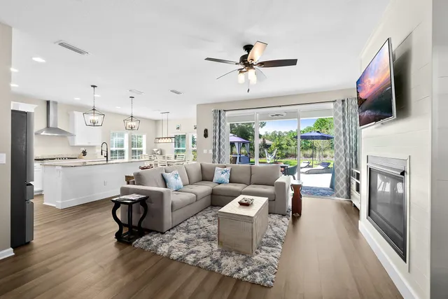 a living room with furniture and kitchen view