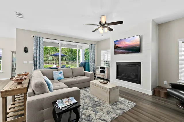 a living room with furniture a fireplace and a flat screen tv
