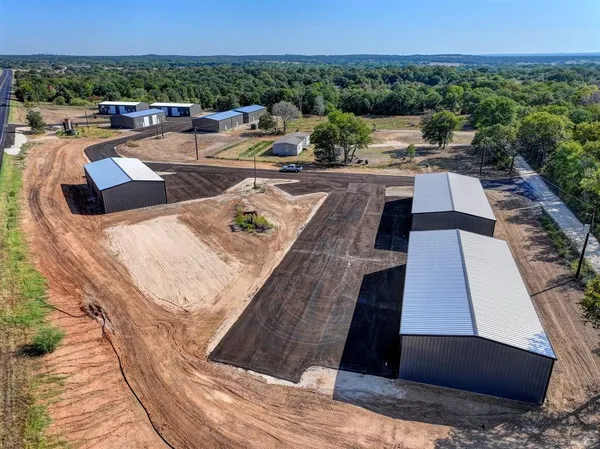 a view of swimming pool with outdoor seating and a garden