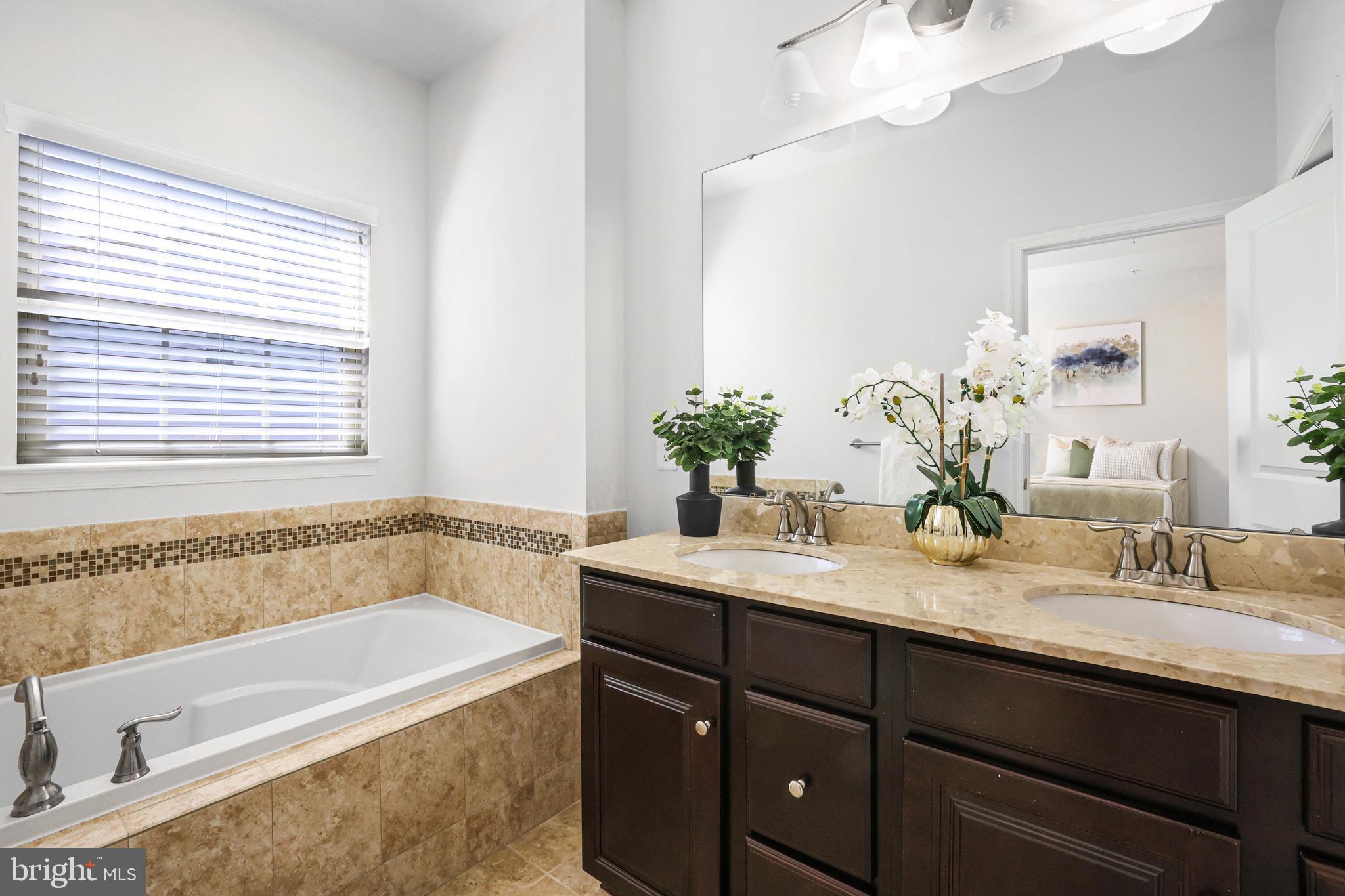 2741 Prospect Hill Drive Hanover, MD 21076 - Photo 24 of 64 a bathroom with a granite countertop bathtub a sink and a window