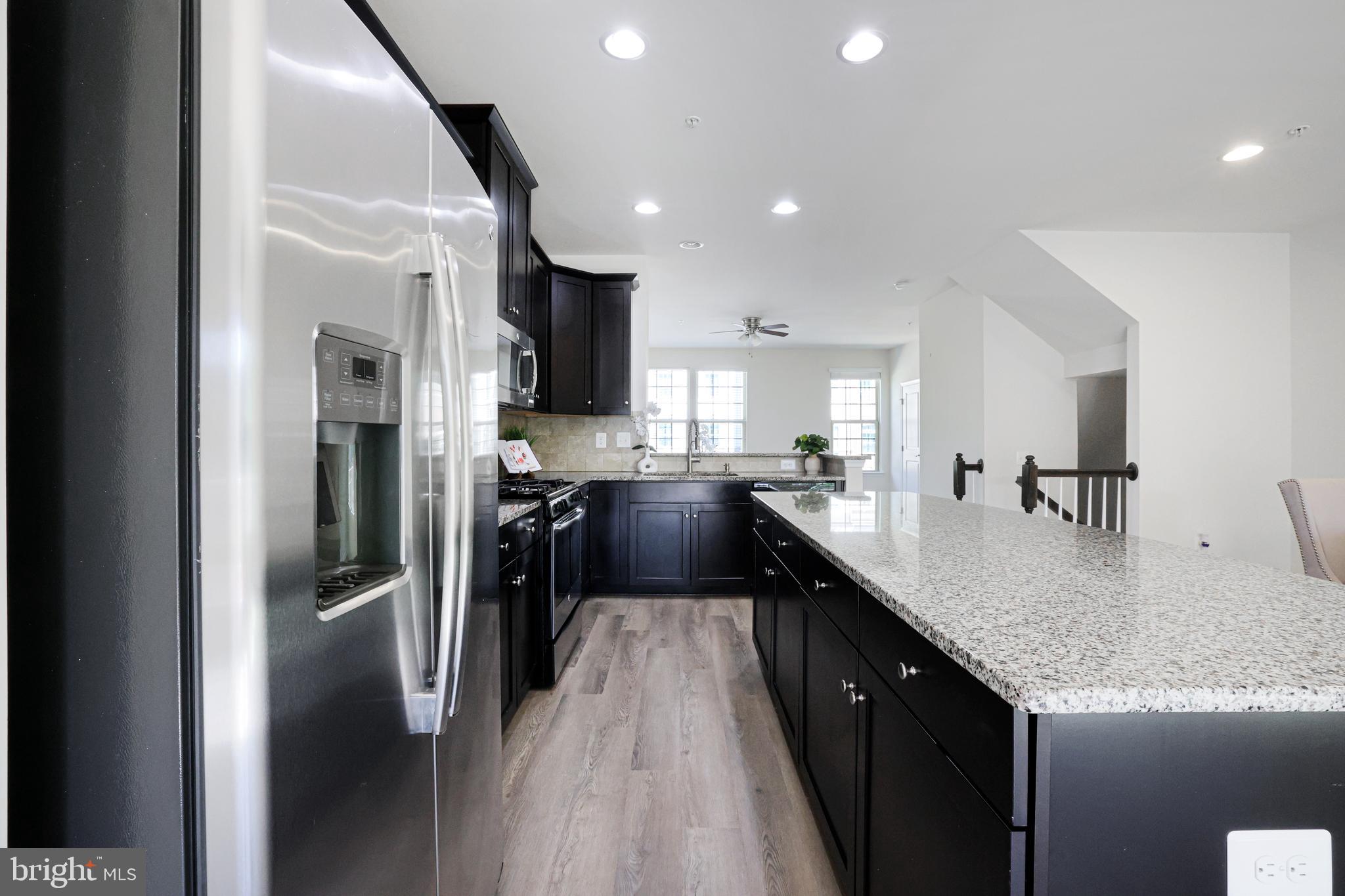 2741 Prospect Hill Drive Hanover, MD 21076 - Photo 5 of 64 a kitchen with stainless steel appliances granite countertop a refrigerator a sink dishwasher a oven with white cabinets and wooden floor