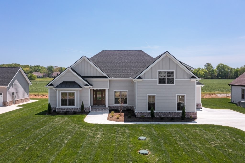 a view of a house with a yard porch and sitting area