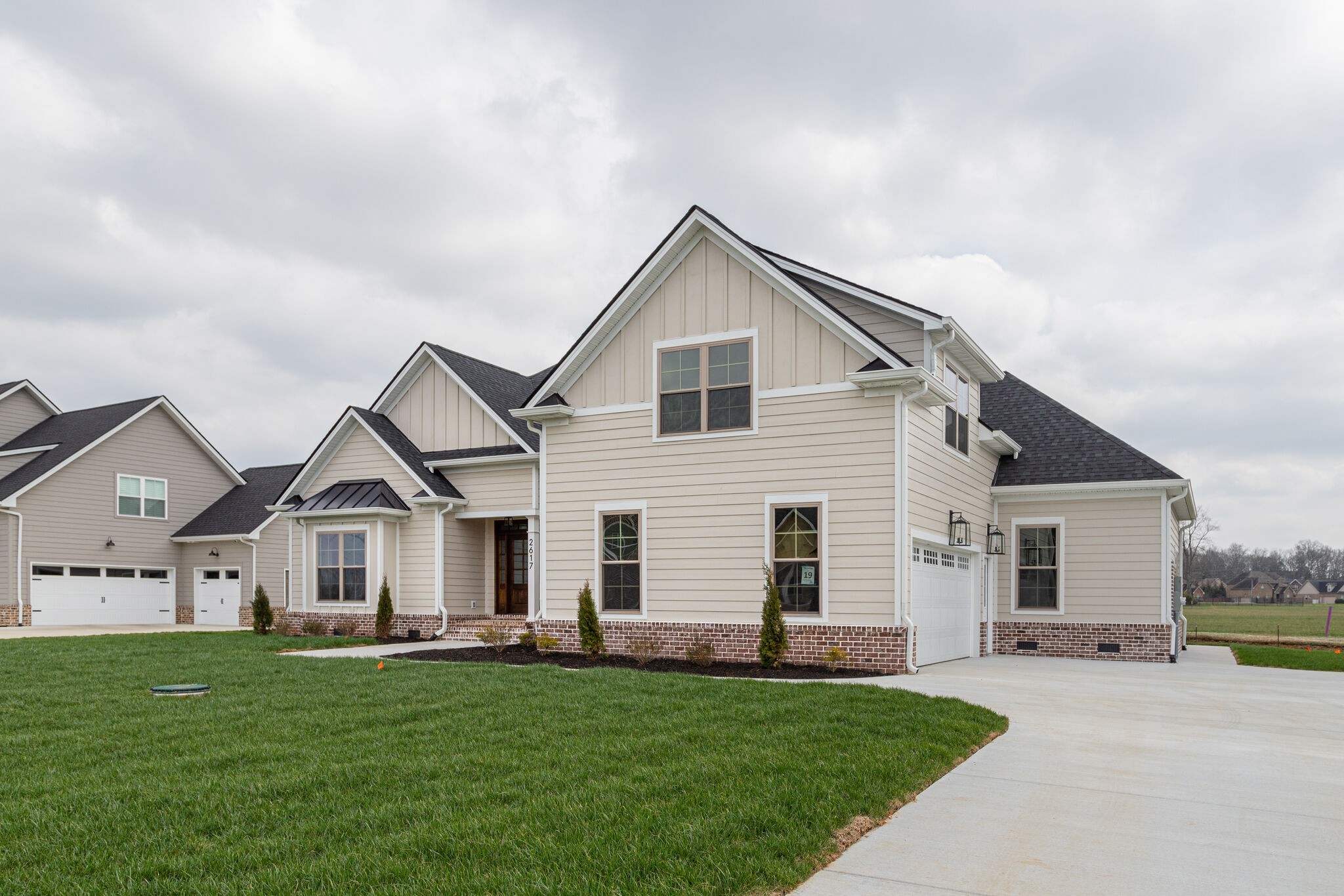 2617 Holly Spring Drive Murfreesboro, TN 37128 - Photo 5 of 50 a view of a white house next to a yard with a big yard and large trees