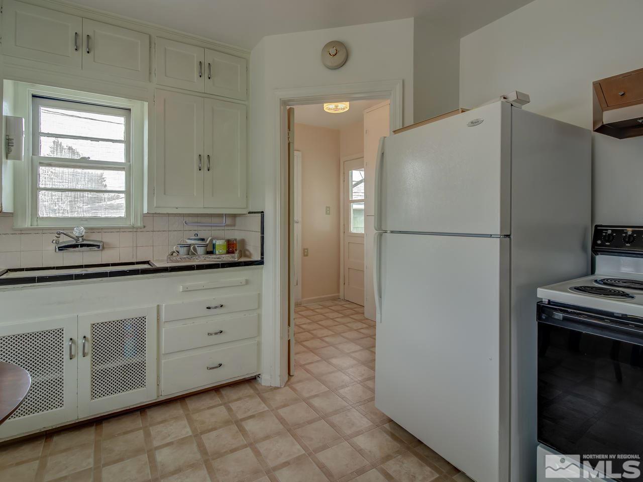 1215 Wheeler Avenue Reno, NV 89502 - Photo 13 of 25 a white refrigerator freezer sitting inside of a kitchen