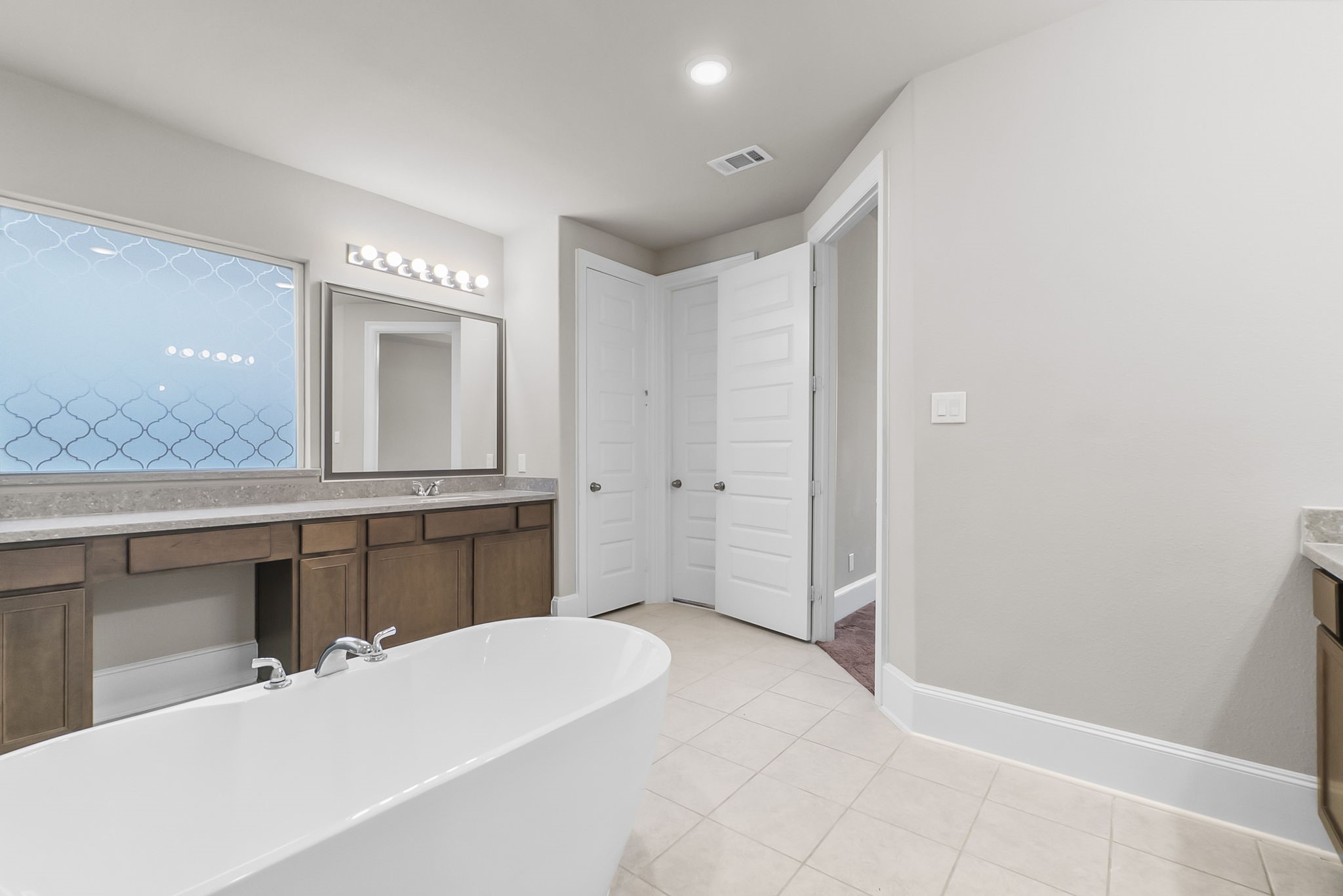 8710 Burdekin Road Magnolia, TX 77354 - Photo 21 of 49 a spacious bathroom with a mirror and a sink