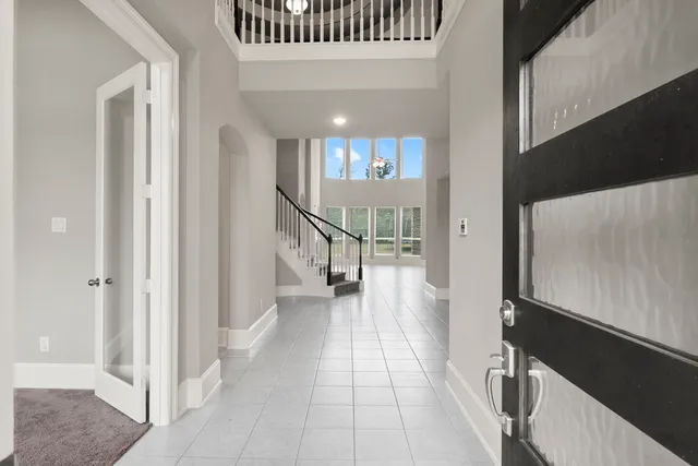 a view of staircase with white walls and a floor to ceiling window