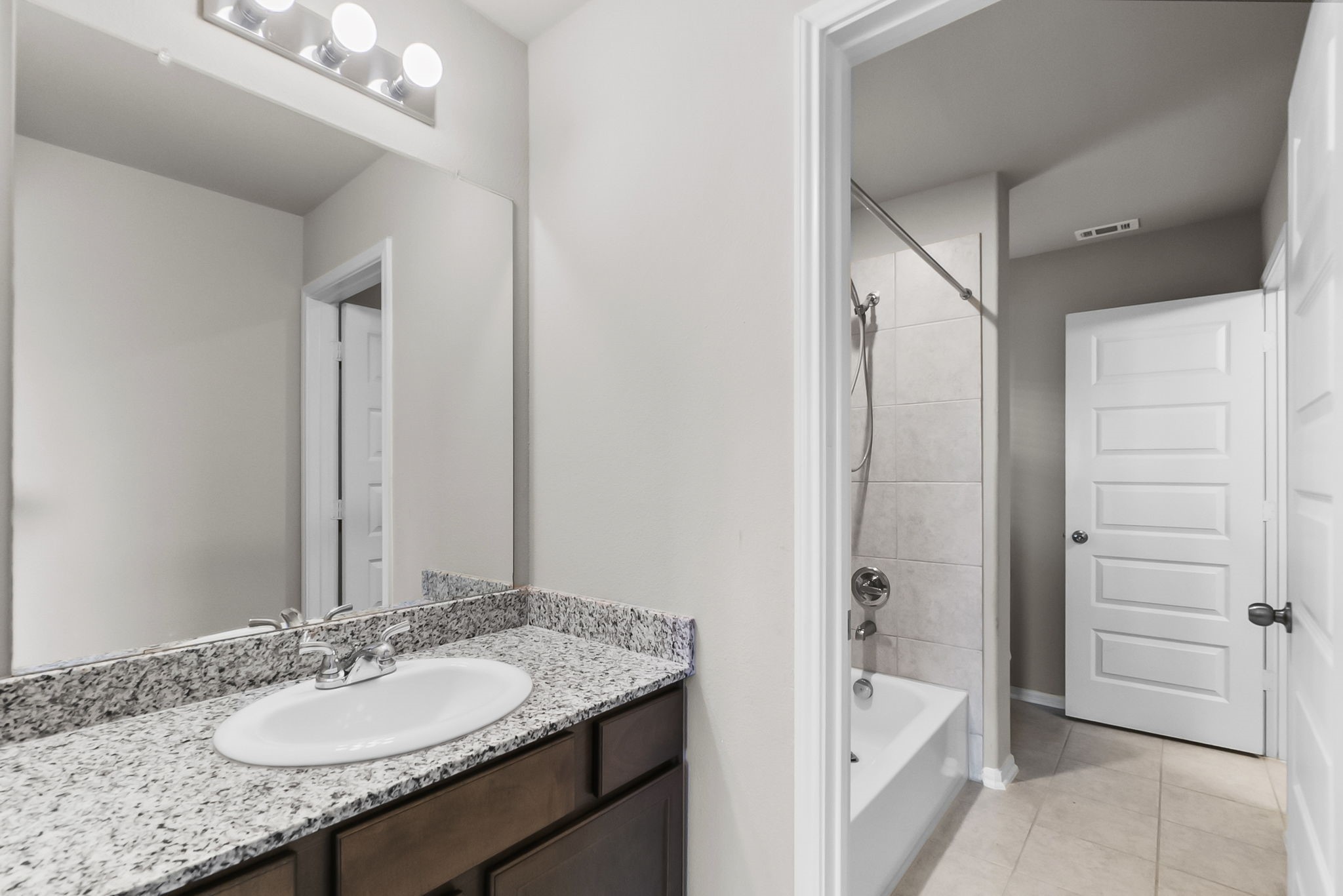 8710 Burdekin Road Magnolia, TX 77354 - Photo 38 of 49 a bathroom with a granite countertop sink and a mirror