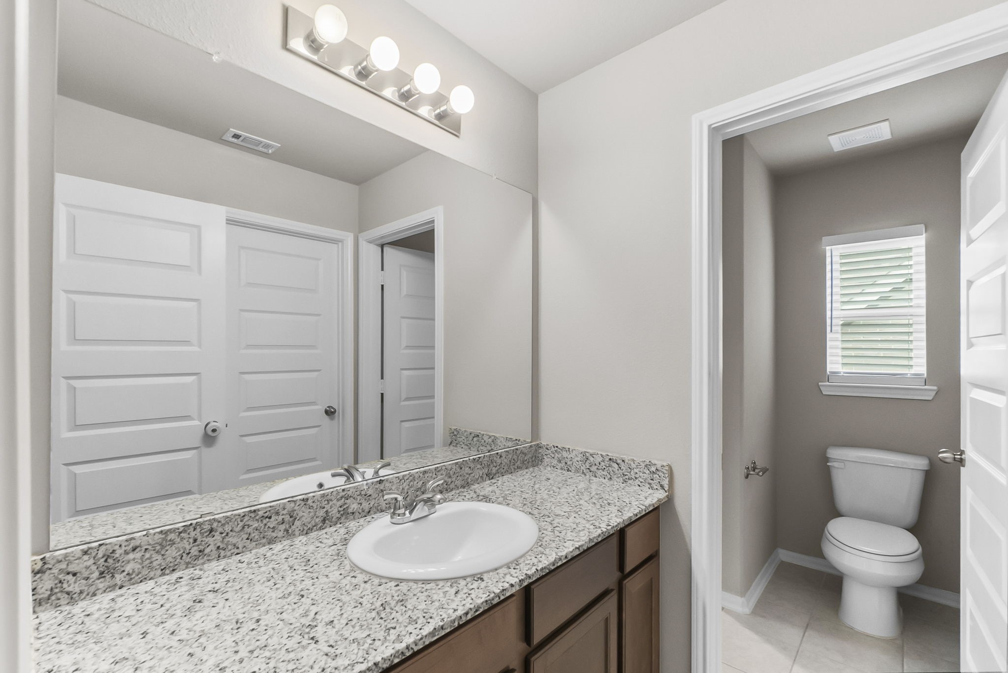 8710 Burdekin Road Magnolia, TX 77354 - Photo 40 of 49 a bathroom with a granite countertop sink toilet and shower