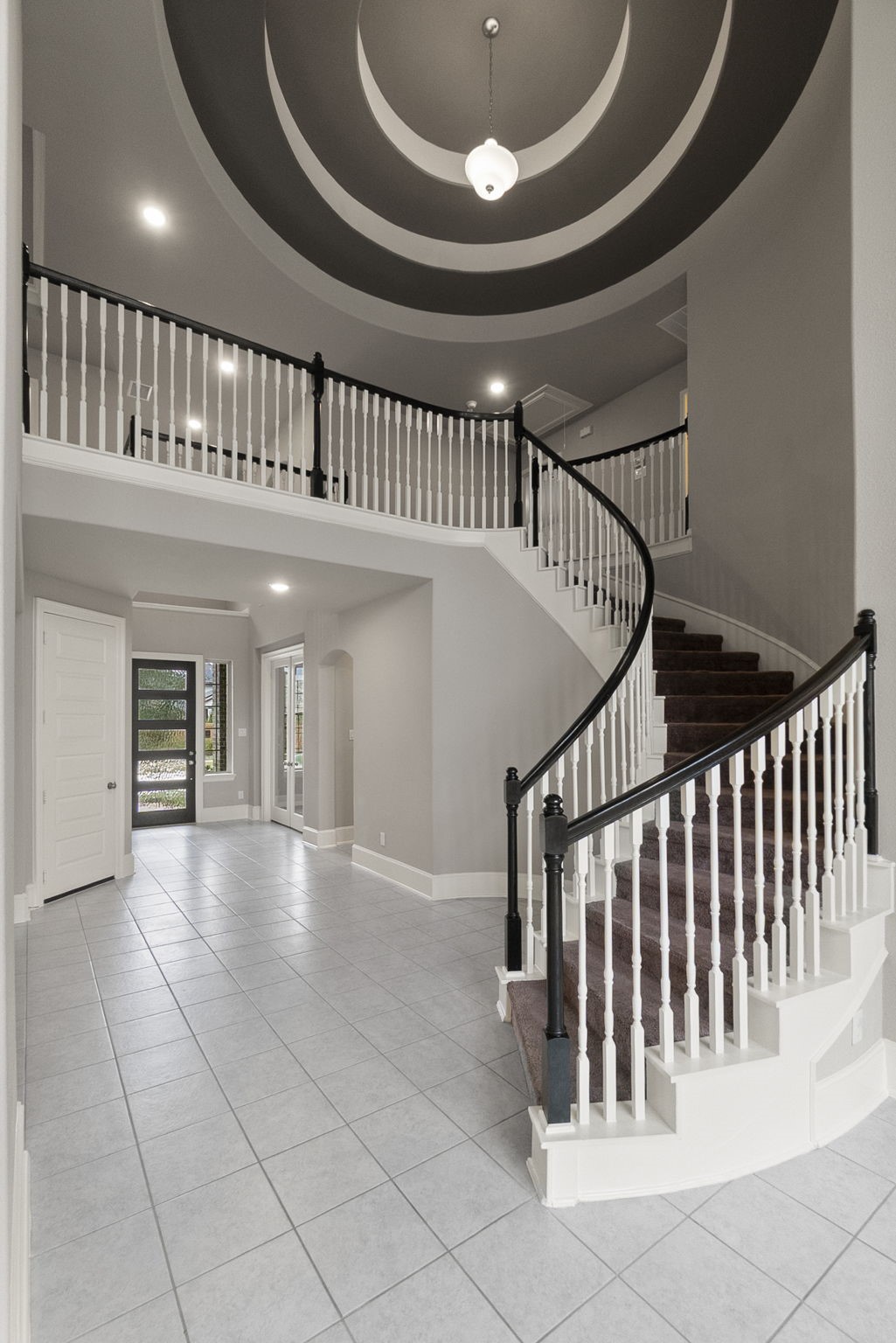 8710 Burdekin Road Magnolia, TX 77354 - Photo 8 of 49 a view of staircase with white walls and a floor to ceiling window