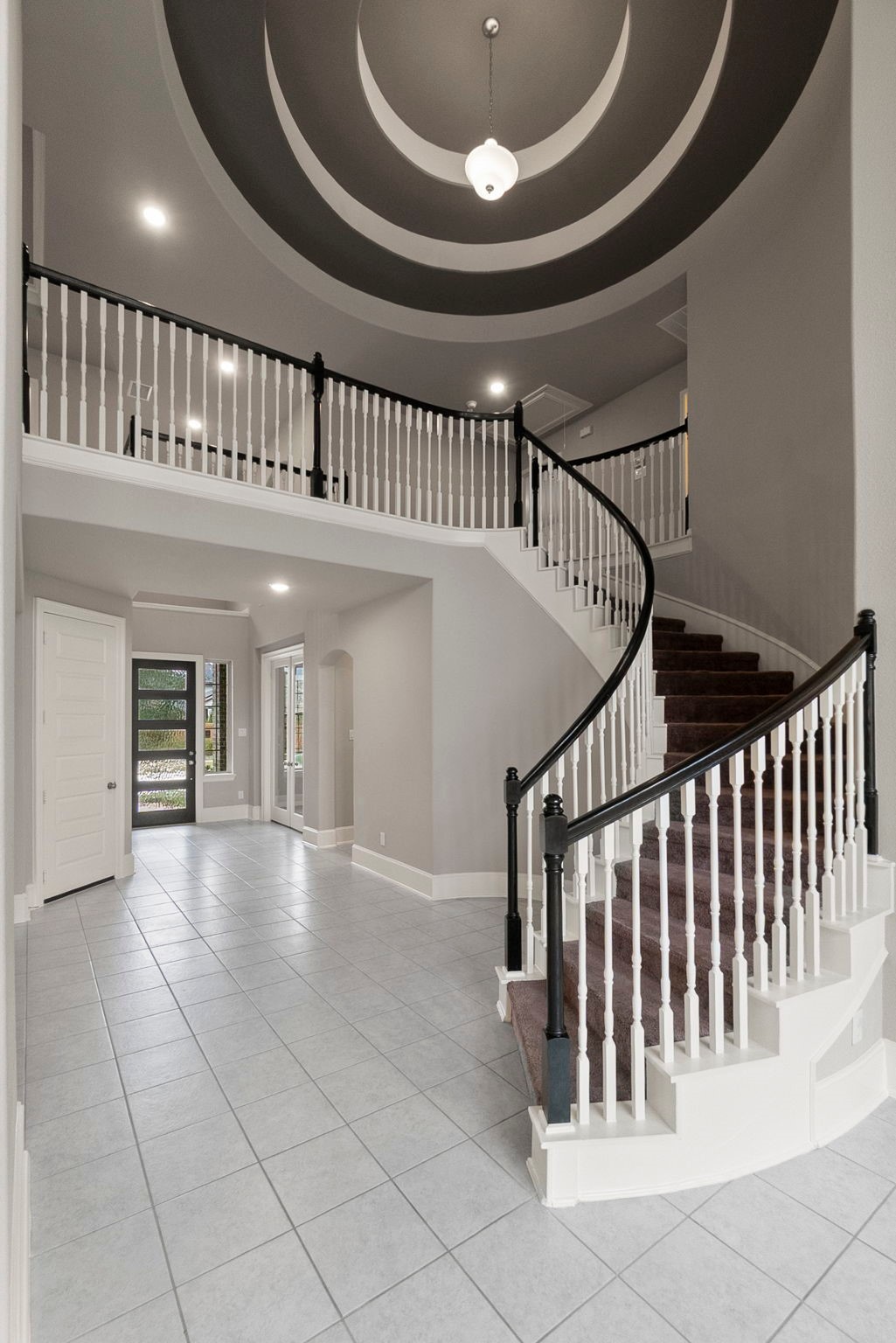 8710 Burdekin Road Magnolia, TX 77354 - Photo 8 of 49 a view of staircase with white walls and a floor to ceiling window