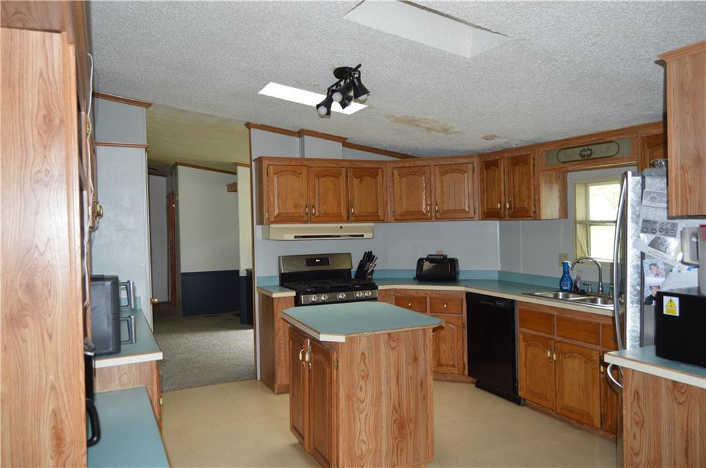 122 Arrowhead Road Emlenton, PA 16373 - Photo 2 of 21 a kitchen with stainless steel appliances a stove top oven a sink a refrigerator and cabinets