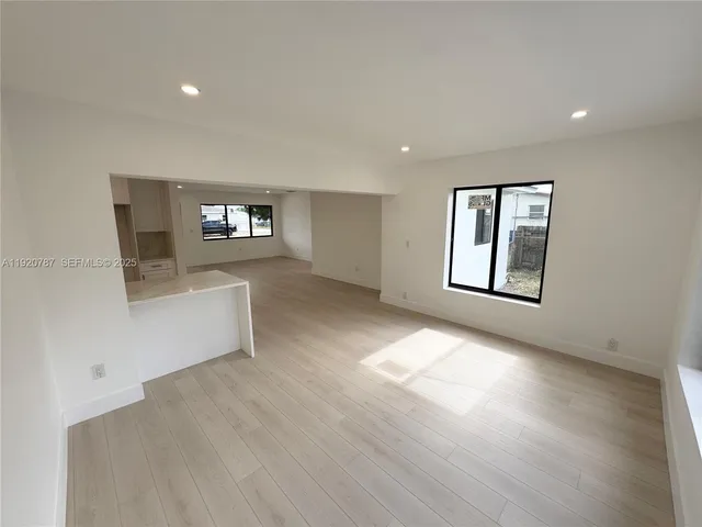 a view of kitchen with microwave and refrigerator