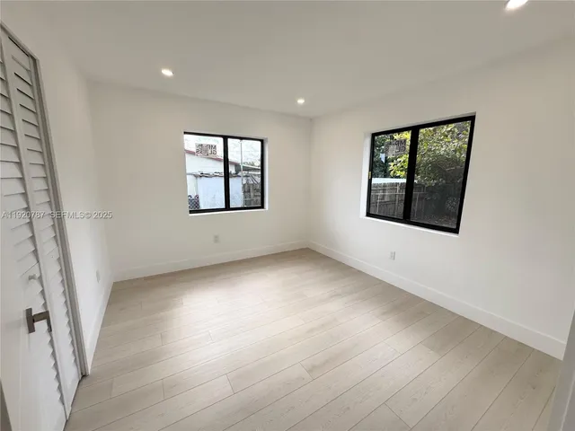 a bathroom with a granite countertop sink toilet a mirror and shower