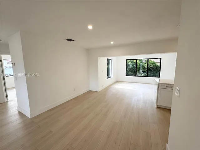 a view of a kitchen with a sink and a large window