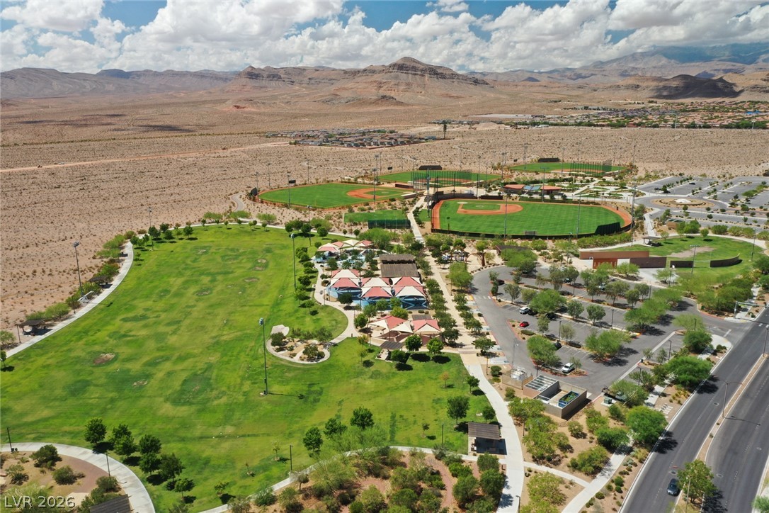9916 Sable Point Street Las Vegas, NV 89178 - Photo 70 of 73 An aerial perspective reveals verdant playing fields nestled against desert mountains.