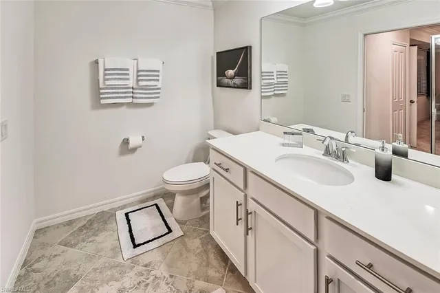 a bathroom with a sink toilet and vanity