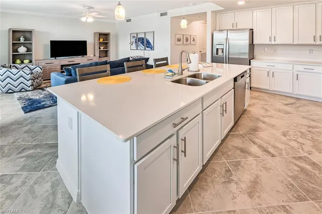 a kitchen with stainless steel appliances a sink and a refrigerator