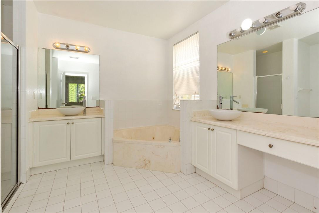 1801 Northwest 3rd Street Pompano Beach, FL 33069 - Photo 12 of 25 a spacious bathroom with a bathtub sink and mirror