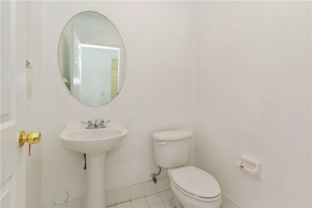 1801 Northwest 3rd Street Pompano Beach, FL 33069 - Photo 14 of 25 a bathroom with a toilet sink and mirror