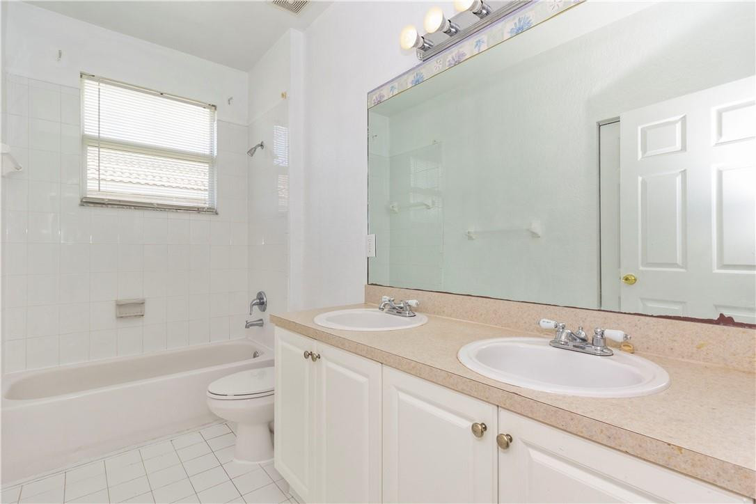 1801 Northwest 3rd Street Pompano Beach, FL 33069 - Photo 17 of 25 a bathroom with a granite countertop sink toilet and shower