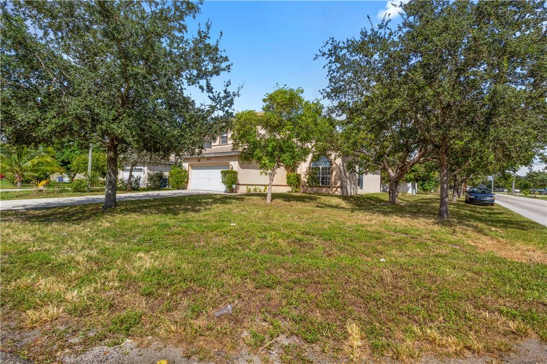 1801 Northwest 3rd Street Pompano Beach, FL 33069 - Photo 4 of 25 a front view of a house with a yard