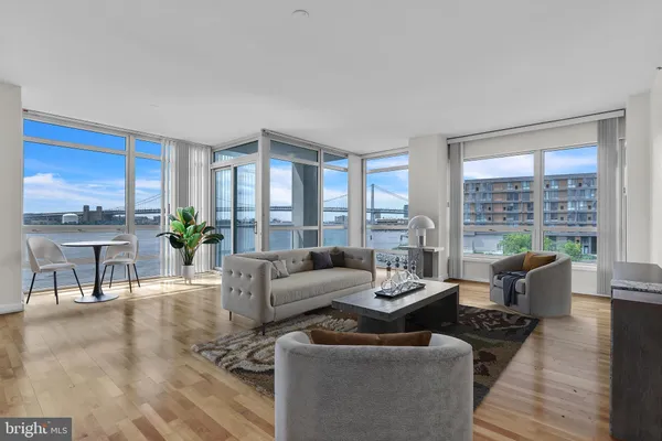 a living room with furniture and large windows