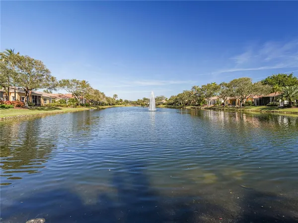a view of a lake with houses in the background