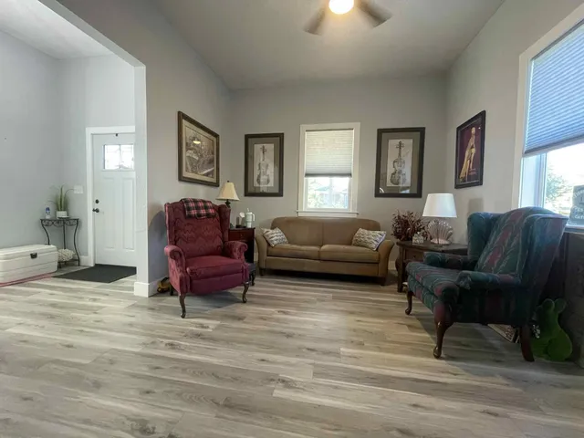 a living room with furniture and a wooden floor
