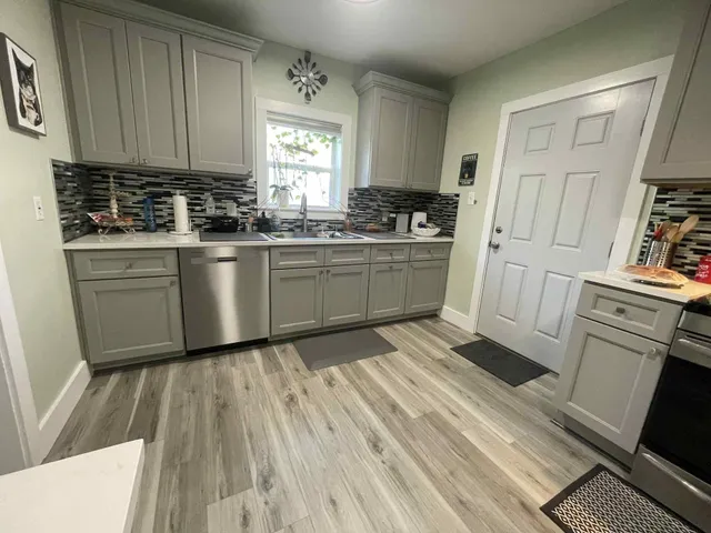 a kitchen with cabinets appliances and a window