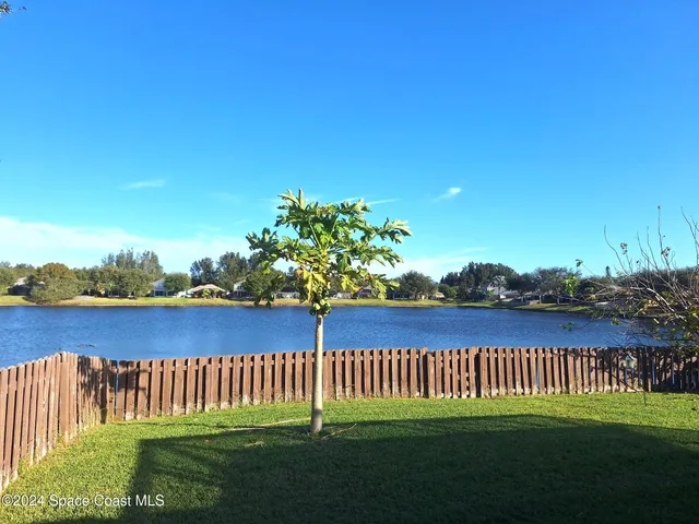 a view of a wooden deck and a yard