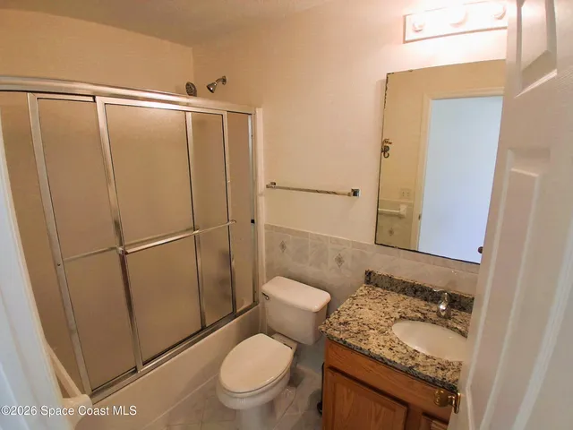 a white toilet sitting next to a small tub