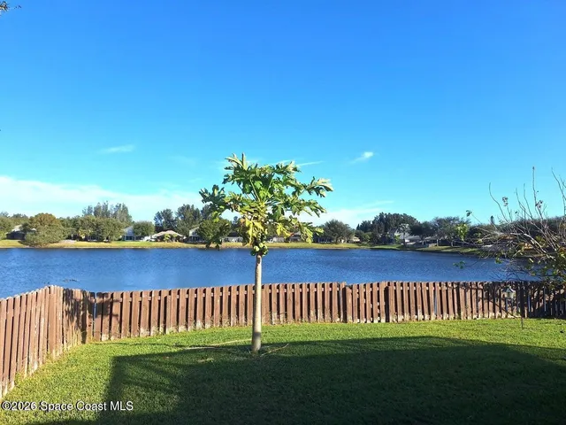 a bedroom with a bed and a ceiling fan