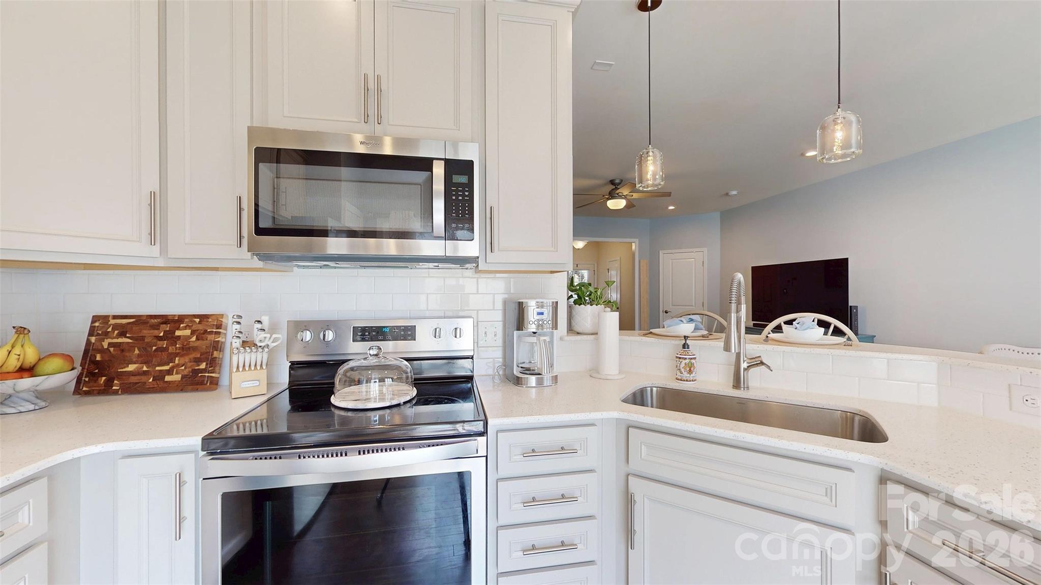 827 Canoe Song Road Fort Mill, SC 29708 - Photo 15 of 33 a kitchen with stainless steel appliances granite countertop a sink a stove and a microwave