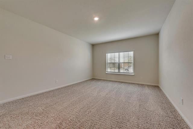 13609 Mineral Road Ponder, TX 76259 - Photo 11 of 21 Spacious room featuring neutral carpeting, light-toned walls, a single window with blinds, and recessed lighting