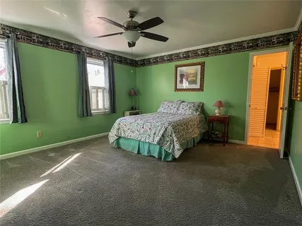 a spacious bedroom with a bed and a window