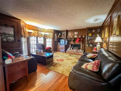 a living room with furniture fireplace and a large window