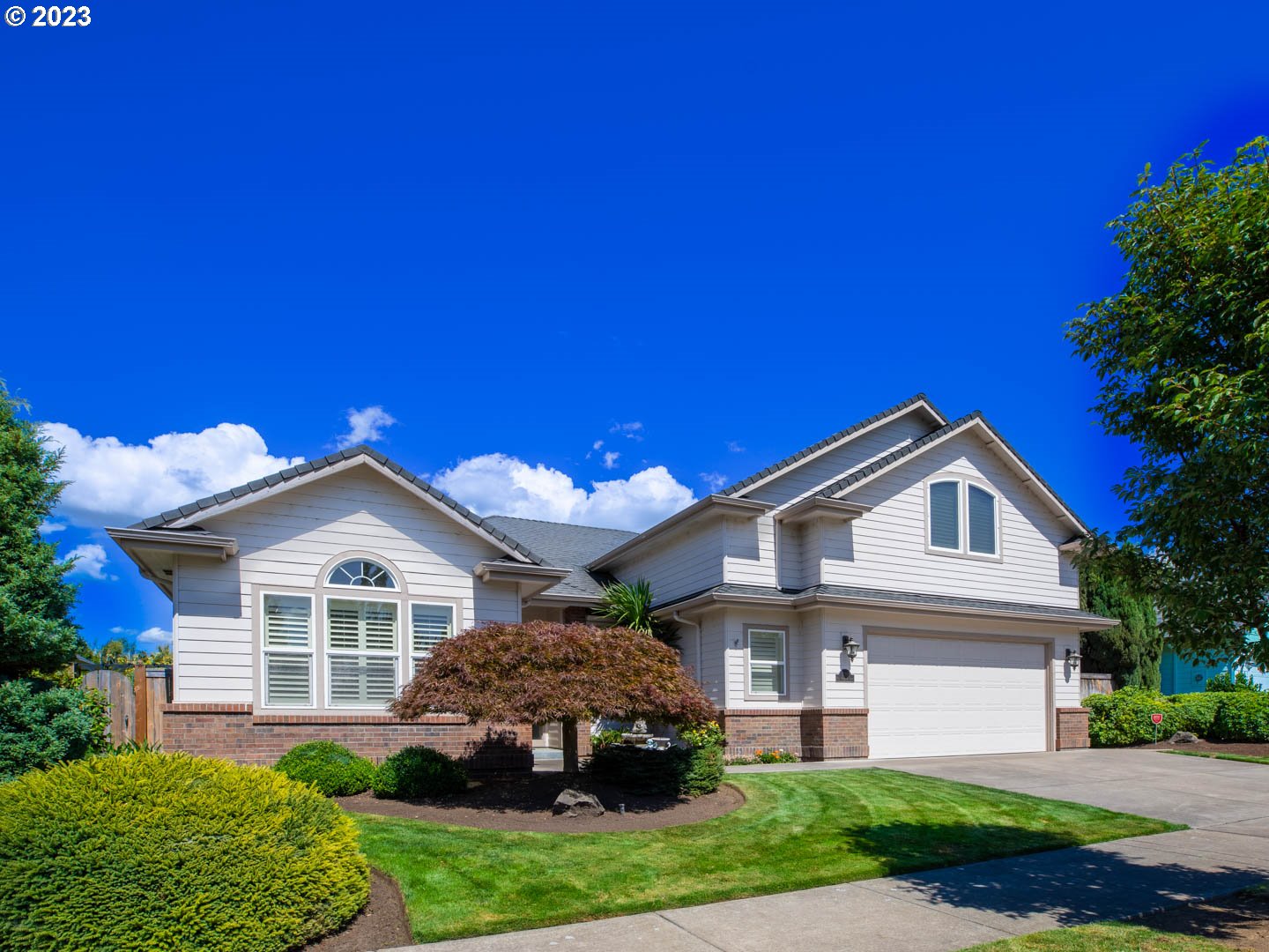 a front view of a house with a yard and garage