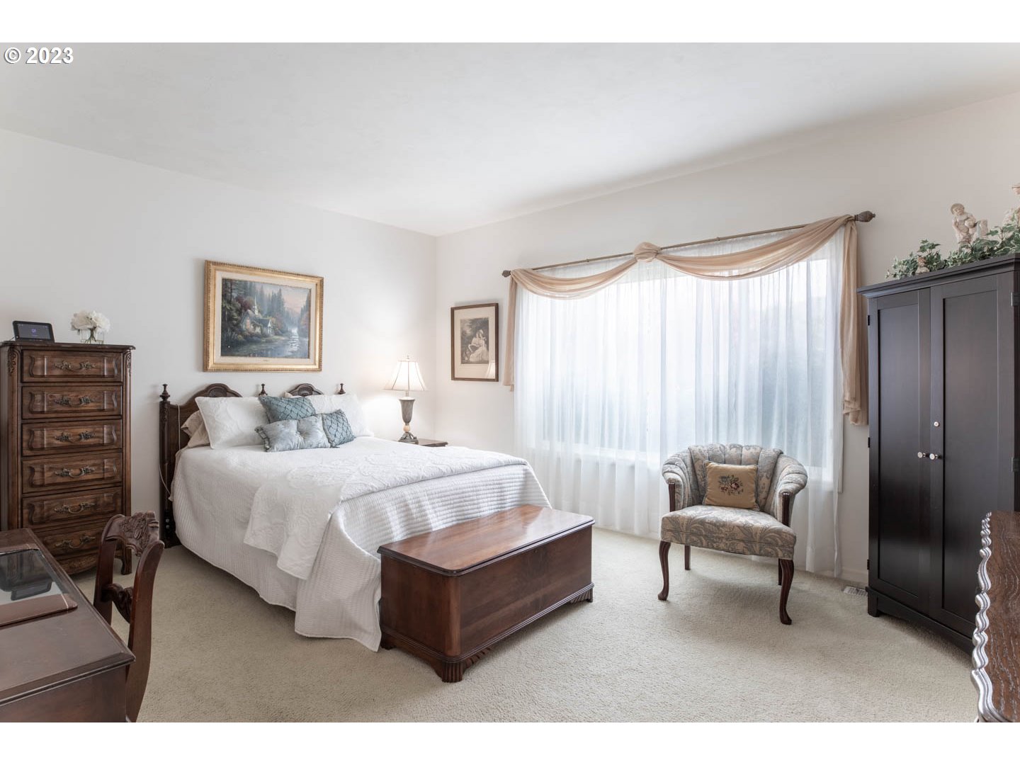 836 Old Orchard Lane Springfield, OR 97477 - Photo 12 of 29 a spacious bedroom with a bed a couch and a window