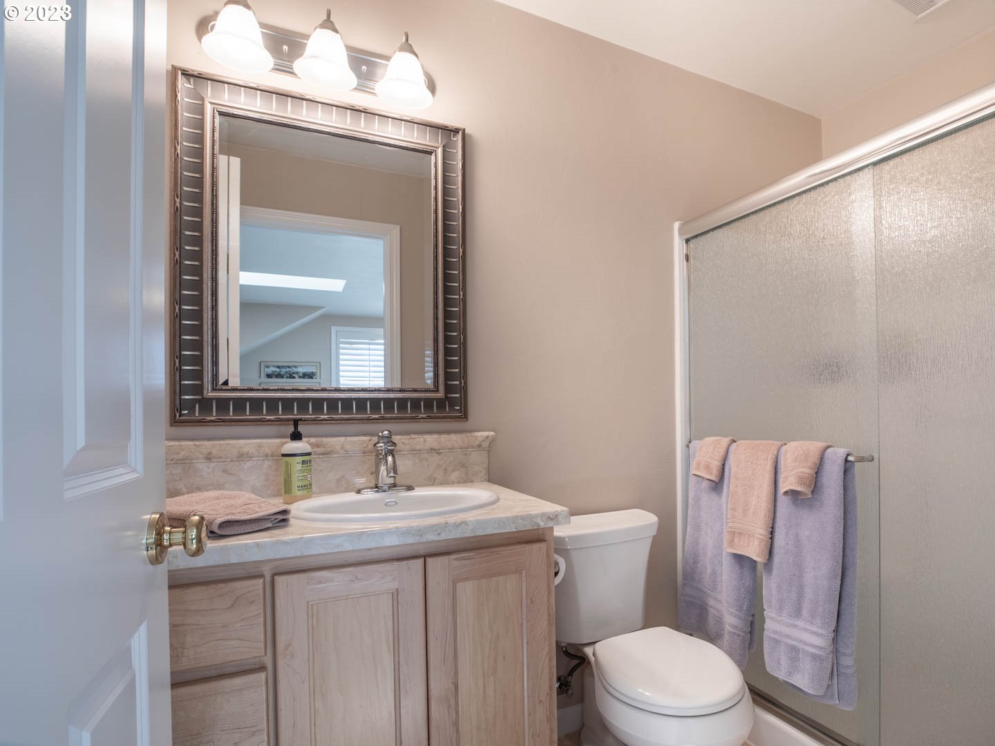 836 Old Orchard Lane Springfield, OR 97477 - Photo 20 of 29 a bathroom with a granite countertop toilet a sink and a mirror