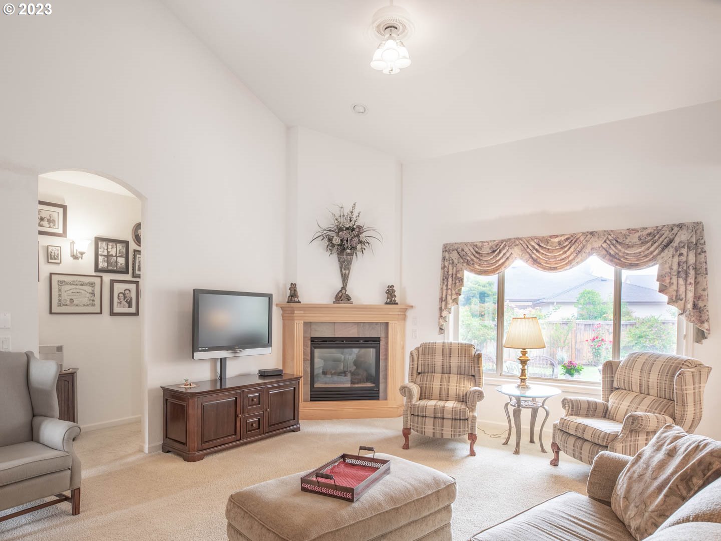 836 Old Orchard Lane Springfield, OR 97477 - Photo 4 of 29 a living room with furniture a flat screen tv and a fireplace