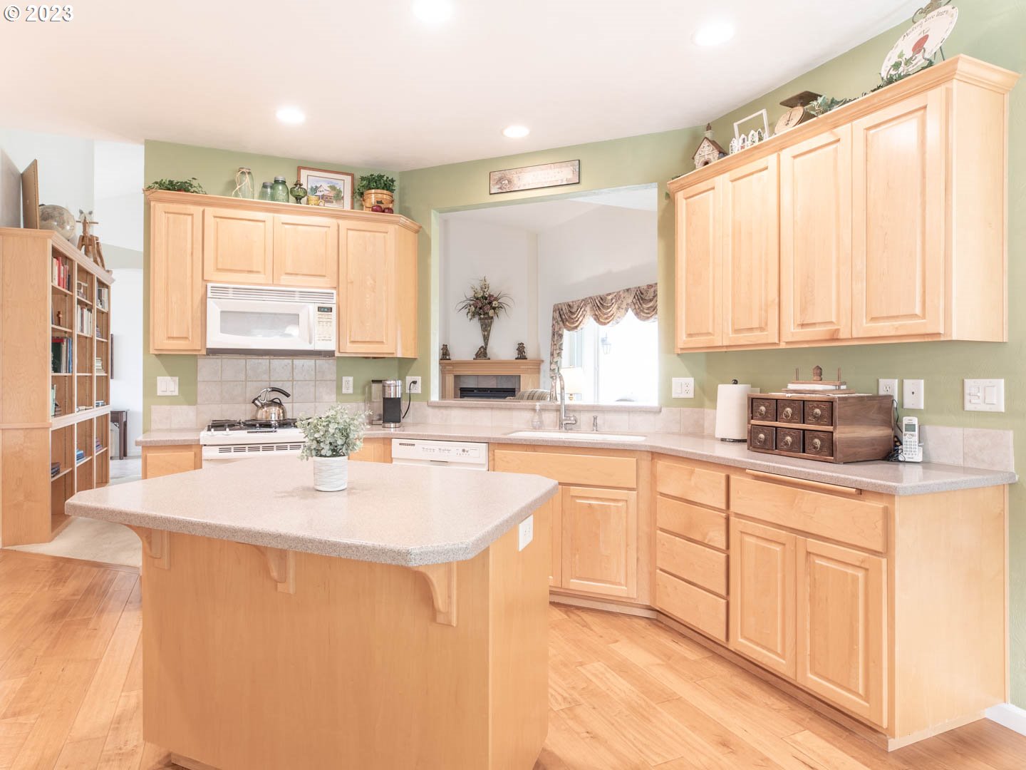 836 Old Orchard Lane Springfield, OR 97477 - Photo 6 of 29 a kitchen with stainless steel appliances granite countertop a sink a stove and white cabinets with wooden floor