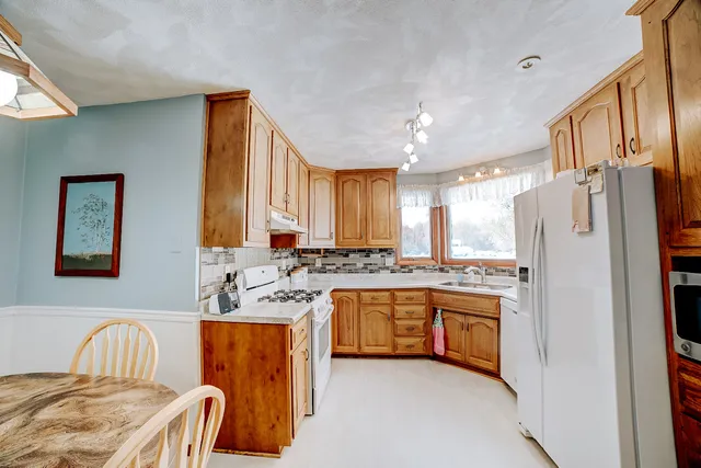 a view of a workspace with furniture and wooden floor
