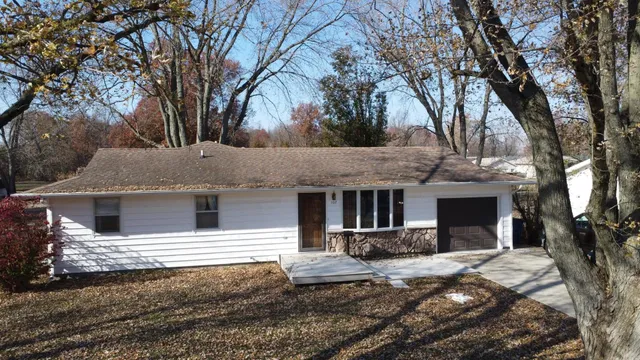 a view of a house with a yard covered in snow