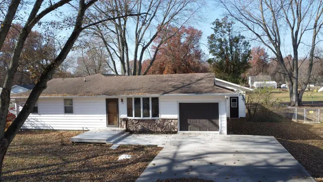 a kitchen with stainless steel appliances a stove a table and chairs