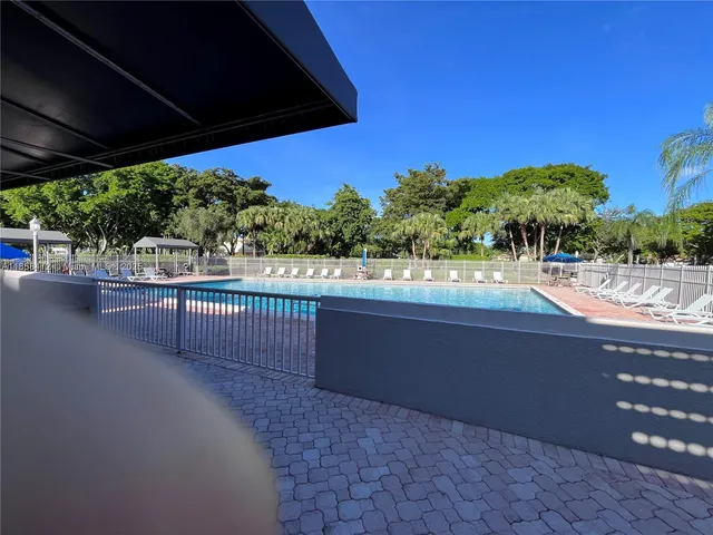 a view of a patio with table and chairs