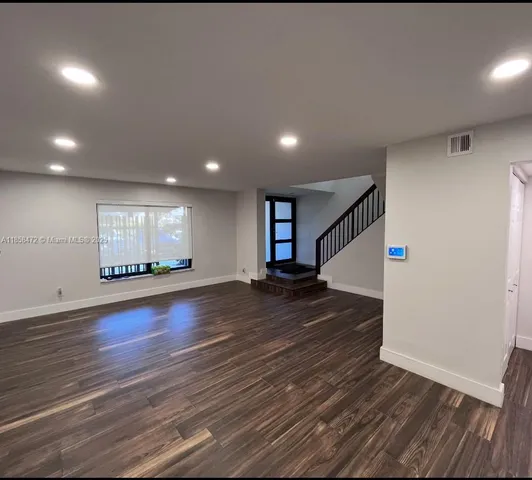 a bathroom with a granite countertop sink toilet and a mirror