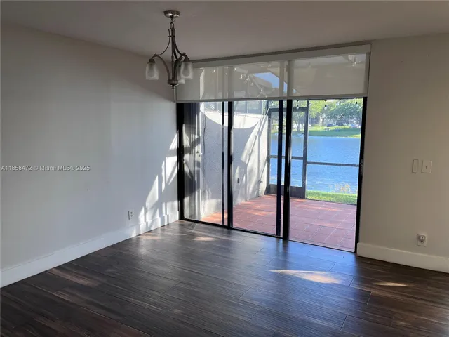 a view of a kitchen with wooden floor and electronic appliances