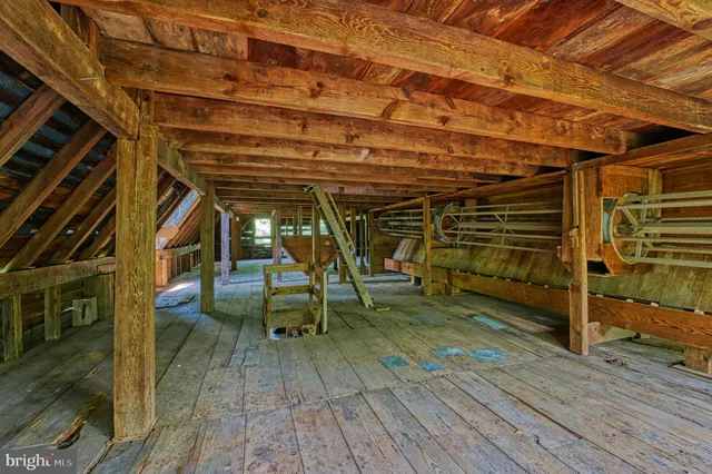 a view of a lush green outdoor space with a swimming pool and valleys in the background