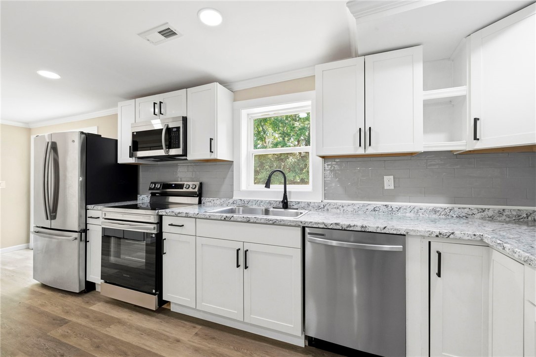 418 Old River Road Pelzer, SC 29669 - Photo 8 of 29 Modern kitchen equipped with stainless steel appliances and ample cabinetry.